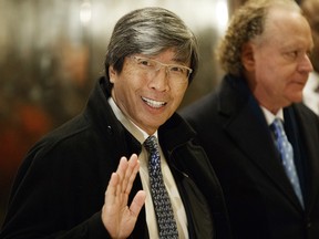FILE - In this Jan. 10, 2017, file photo, pharmaceuticals billionaire Dr. Patrick Soon-Shiong waves as he arrives in the lobby of Trump Tower in New York for a meeting with President-elect Donald Trump.