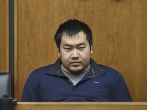 Jeffrey Yao is brought into Woburn District Court, Monday, Feb. 26, 2018 in Woburn, Mass. Yao is arraigned on murder charges and attempted murder after allegedly stabbing a woman to death and attempting to stab a man to death in the Winchester Public Library.