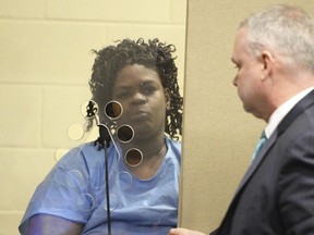 Latarsha Sander, 43, is arraigned in Brockton, Mass., District Court on two counts of murder, on Tuesday, Feb. 6, 2018 with her defense attorney Joseph Krowski. Jr.   A prosecutor says the Massachusetts woman who stabbed her two young children to death did so as part of a "ritual." Authorities say  Sanders told police she attacked her 8-year-old son with a kitchen knife as part of a ritual but failed, and so she attacked her 5-year-old son.
