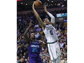 Boston Celtics forward Jayson Tatum (0) drives to the basket against Charlotte Hornets guard Treveon Graham (21) during the first quarter of an NBA basketball game in Boston, Wednesday, Feb. 28, 2018.