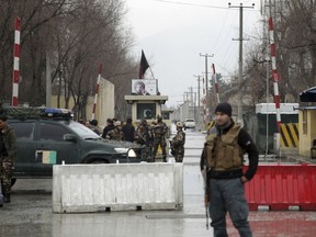 Security forces inspect the site of a suicide bombing in the diplomatic area of capital Kabul, Afghanistan, Saturday, Feb. 24, 2018.  Interior ministry spokesman Najib Danish said several people were wounded in Saturday's attack in the Shash Darak area of Kabul, near NATO headquarters and not far from the U.S. Embassy.