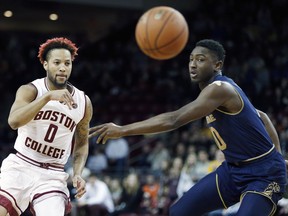 Boston College's Ky Bowman (0) passes against Notre Dame's TJ Gibbs during the first half of an NCAA college basketball game in Boston, Saturday, Feb. 17, 2018.