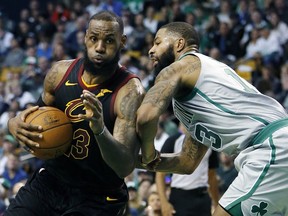 Cleveland Cavaliers' LeBron James (23) drives past Boston Celtics' Marcus Morris (13) during the third quarter of an NBA basketball game in Boston, Sunday, Feb. 11, 2018. The Cavaliers won 121-99.