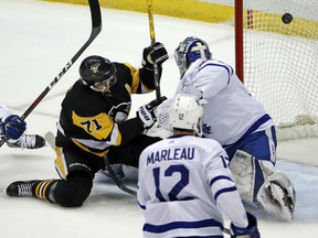 Evgeni Malkin of the Penguins puts the puck behind Toronto Maple Leafs netminder Frederik Andersen for a goal during the first period of their game in Pittsburgh on Saturday night.