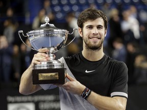Karen Khachanov of Russia holds his trophy after defeating Lucas Pouille of France during their final match at the Open 13 Provence tennis tournament in Marseille, southern France, Sunday Feb.25, 2018.