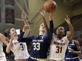 Notre Dame forward Kathryn Westbeld (33) vies for control of a rebound with Boston College guards Andie Anastos (3) and Sydney Lowery (31) in the first half of an NCAA college basketball game, Sunday, Feb. 18, 2018, in Boston.