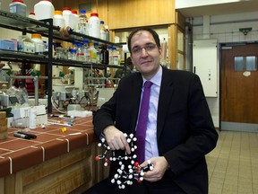 In this Feb. 1, 2012 file photo, Prof. Peter Seeberger, a former Massachusetts Institute of Technology professor who now teaches at Berlin's Free University poses with a  molecule model at his laboratory in Berlin, Germany. Scientists in Germany who developed a new way to make a key malaria drug several years ago said Wednesday Feb. 21, 2018 they have come up with a technique to make the process even more efficient, which should increase global access and reduce the cost. "This development has the potentiation to save millions of lives by increasing the global access and reducing the cost of anti-malaria medicine," Peter Seeberger, director of the Max Planck Institute unit working on the issue.