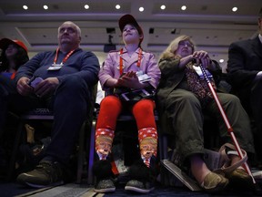 Millie March, 12, of Fairfax, Va., center, wears socks featuring President Donald Trump while awaiting his speech to the Conservative Political Action Conference (CPAC), at National Harbor, Md., Friday, Feb. 23, 2018.