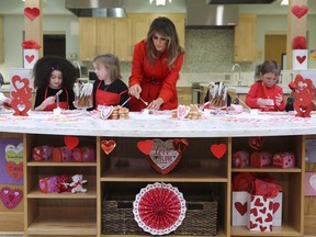 First lady Melania Trump helps decorate cookies during her visit to the Children's Inn at the National Institute of Health, Wednesday, Feb. 14, 2018, in Bethesda, Md.
