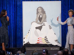 Former first lady Michelle Obama and artist Amy Sherald stand next to Obama's portrait. Portraits of Michelle Obama and former president Barack Obama were unveiled at the Smithsonian National Portrait Gallery in Washington on Feb. 12.