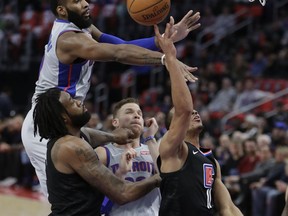 Detroit Pistons center Andre Drummond, top left, blocks a shot by Los Angeles Clippers guard Avery Bradley (11) during the first half of an NBA basketball game, Friday, Feb. 9, 2018, in Detroit.