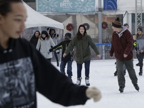 In this Jan. 26, 2018 photo, people skate at the Campus Martius ice rink in Detroit. Some cities and regions are dangling racial diversity along with positive business climates, competitive tax rates and available land in pitches to lure tech companies and high-paying jobs to town. Places such as Pittsburgh, Philadelphia and Detroit are touting their populations of people of color to chief executives and other corporate officials as part of being open for business.