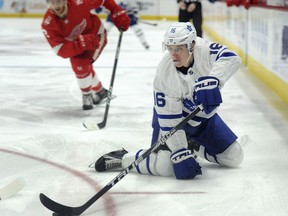 Toronto Maple Leafs center Mitchell Marner (16) sweeps the puck away from Detroit Red Wings defenseman Nick Jensen (3) during the first period of an NHL hockey game, Sunday, Feb. 18, 2018, in Detroit.