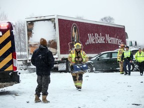 Emergency personnel work at the scene on Interstate 94, Friday, Feb. 9, 2018, near Galesburg, Mich., after scores of vehicles were involved in an accident.