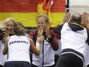 Tatjana Maria of Germany and team captain Jens Gerlach celebrates with teammates their victory during the Fed Cup World Group first round tennis match against Vera Lapko of Belarus in Minsk, Belarus, Sunday, Feb. 11, 2018.