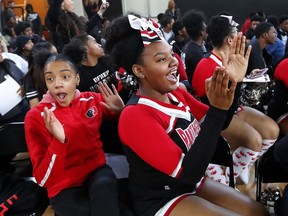 In this Feb. 16, 2018, photo, University Prep Academy High School students react in Detroit to an announcement that all 600 students will see the film "Black Panther." As the film debuts in theaters across the U.S., educators, philanthropist, celebrities, and business owners are pulling together their resources to bring children of color to see the film which features a black superhero in a fictional, un-colonized African nation.