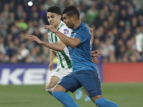 Real Madrid's Casemiro, right, and Betis', Bartra, challenge for the ball during La Liga soccer match between Betis and Real Madrid at the Villamarin stadium, in Seville, Spain, on Sunday, Feb. 18, 2018.