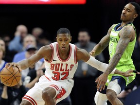 Minnesota Timberwolves' Jeff Teague (0) guards Chicago Bulls' Kris Dunn (32) during the first quarter of an NBA basketball game on Saturday, Feb. 24, 2018, in Minneapolis.