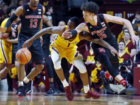 Minnesota's Dupree McBrayer, left, and Nebraska's Isaiah Roby chase a loose ball in the first half of an NCAA college basketball game Tuesday, Feb. 6, 2018, in Minneapolis.