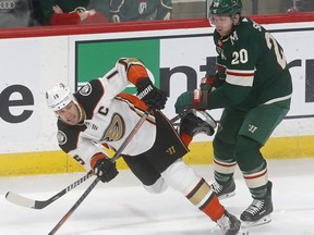 Anaheim Ducks' Ryan Getzlaf, left, gets a shove to the ice by Minnesota Wild's Ryan Suter in the first period of an NHL hockey game Saturday, Feb. 17, 2018, in St. Paul, Minn.