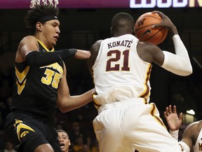 Minnesota's Bakary Konate of Mali beats Iowa's Cordell Pemsl, left, to the rebound in the first half of an NCAA college basketball game Wednesday, Feb. 21, 2018, in Minneapolis.