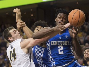 Kentucky's Jarred Vanderbilt, right, Nick Richards, centers and Missouri's Reed Nikko, left, battle for rebound during the first half of an NCAA college basketball game Saturday, Feb. 3, 2018, in Columbia, Mo.