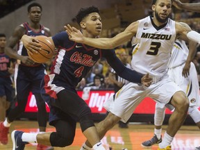 Mississippi's Breein Tyree, left, dribbles past Missouri's Kassius Robertson, right, during the first half of an NCAA college basketball game Tuesday, Feb. 20, 2018, in Columbia, Mo.
