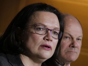 Social Democratic Party, SPD, parliament faction leader and designated party's chairwoman Andrea Nahles, left, and Hamburg's mayor Olaf Scholz, right, attend a news conference at the party's headquarters in Berlin, Tuesday, Feb. 13, 2018.