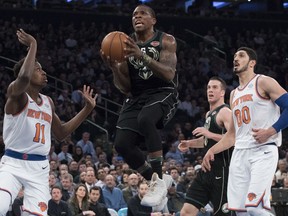 Milwaukee Bucks guard Eric Bledsoe (6) goes to the basket past New York Knicks guard Frank Ntilikina (11) and center Enes Kanter (00) during the first half of an NBA basketball game Tuesday, Feb. 6, 2018, at Madison Square Garden in New York.