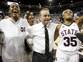 Mississippi State head coach Vic Schaefer, center, Zion Campbell, left, and Victoria Vivians (35) celebrate their 67-53 win over South Carolina in their NCAA college basketball game in Starkville, Miss., Monday, Feb. 5, 2018. Mississippi State stays undefeated for the season.