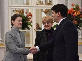 Serbian Prime Minister Ana Brnabic, left, shakes hands with Hungarian President Janos Ader during their meeting in the presidential Alexander Palace in Budapest, Hungary, Friday, Feb. 9, 2018.