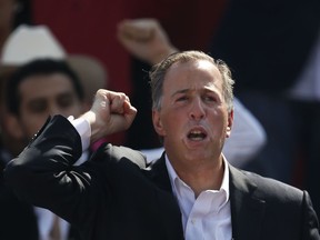 Jose Antonio Meade gestures to supporters during an event naming him the presidential candidate for the Institutional Revolutionary Party (PRI) in Mexico City, Sunday, Feb. 18, 2018. On Sunday, Mexico's three major political parties are nominating their presidential candidates for the July 1 election.