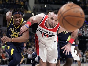 Washington Wizards center Marcin Gortat (13) and Indiana Pacers center Myles Turner (33) go for a loose ball during the first half of an NBA basketball game in Indianapolis, Monday, Feb. 5, 2018.