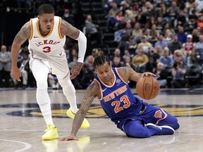 New York Knicks guard Trey Burke (23) goes the the floor to keep his dribble in front of Indiana Pacers guard Joe Young (3) during the first half of an NBA basketball game in Indianapolis, Sunday, Feb. 11, 2018.