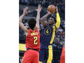 Indiana Pacers guard Victor Oladipo (4) shoots over Atlanta Hawks guard Tyler Dorsey (2) during the first half of an NBA basketball game in Indianapolis, Friday, Feb. 23, 2018.