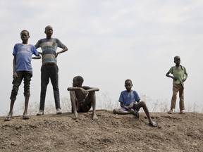 In this photo taken Saturday, Jan. 20, 2018, children stand on the banks of the Nile overlooking the Ethiopian border in Akobo town, one of the last rebel-held strongholds in South Sudan. Child abductions have risen during South Sudan's civil war as desperate people try to make a living, and one child, no matter the age, is said to sell for 20 cows, worth about $7,000.