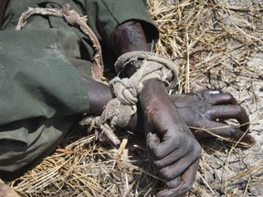 FILE - In this Sunday, Oct. 16, 2016 file photo, the body of a rebel soldier who died in a battle days before has his hands tied, in Malakal, South Sudan. The latest report on human rights abuses in South Sudan's five-year civil war, released by a United Nations commission Friday, Feb. 23, 2018 says it has identified more than 40 senior military officials "who may bear individual responsibility for war crimes."