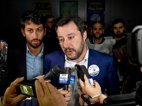 Leader of The League party, Matteo Salvini, answers reporters' questions as he attends an electoral meeting ahead of March 4 Italy's general elections, in Calvizzano, near Naples, Italy, Wednesday, Feb. 21, 2018.