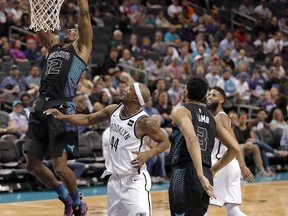 Charlotte Hornets' Dwight Howard (12) dunks as Brooklyn Nets' Dante Cunningham (44) watches during the first half of an NBA basketball game in Charlotte, N.C., Thursday, Feb. 22, 2018.