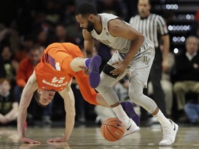 Clemson's David Skara (24) and Wake Forest's Keyshawn Woods (1) battle for control of a loose ball during the first half of an NCAA college basketball game in Winston-Salem, N.C., Saturday, Feb. 3, 2018.
