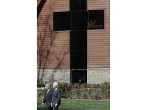 Former President Bill Clinton, right, walks with Franklin Graham to pay respects to Billy Graham during a public viewing at the Billy Graham Library in Charlotte, N.C., Tuesday, Feb. 27, 2018.