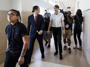 FILE - In a Thursday, Aug. 17, 2017 file photo, from left, Ngoc Loan Tran, 24, Peter Gull Gilbert, 36, and Dante Strobino, 35, leave a courtroom in the Durham County Courthouse after their first court appearance after being arrested for the toppling of the Durham County confederate statue during a protest, in Durham, NC. A North Carolina judge trying protesters accused of toppling a Confederate statue  on Monday, Feb. 19, 2018, dismissed the criminal case against Strobino.