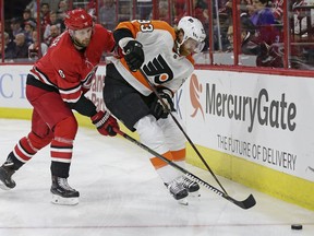 Carolina Hurricanes' Klas Dahlbeck (6), of Sweden, chases the puck with Philadelphia Flyers' Jakub Voracek (93), of the Czech Republic, during the first period of an NHL hockey game in Raleigh, N.C., Tuesday, Feb. 6, 2018.