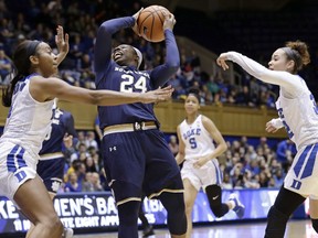 Notre Dame's Arike Ogunbowale (24) drives to the basket while Duke's Jayda Adams, right, and Lexie Brown defend during the first half of an NCAA college basketball game in Durham, N.C., Sunday, Feb. 4, 2018.