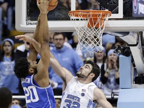 North Carolina's Luke Maye (32) guards Duke's Marques Bolden (20) during the first half of an NCAA college basketball game in Chapel Hill, N.C., Thursday, Feb. 8, 2018.