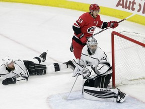 Carolina Hurricanes' Jeff Skinner (53) scores against Los Angeles Kings goalie Darcy Kuemper (35) as Kings' Jake Muzzin (6) falls to the ice to block during the third period of an NHL hockey game in Raleigh, N.C., Tuesday, Feb. 13, 2018. Carolina won 7-3.