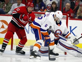 Carolina Hurricanes' Jeff Skinner (53) battles with New York Islanders' Ryan Pulock (6) during the first period of an NHL hockey game Friday, Feb. 16, 2018, in Raleigh, N.C.