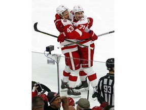 Detroit Red Wings' Darren Helm (43) is congratulated on his goal by teammate Dylan Larkin (71) during the third period of the team's NHL hockey game against the Carolina Hurricanes, Friday, Feb. 2, 2018, in Raleigh, N.C.