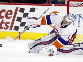 New York Islanders goaltender Thomas Greiss blocks a shot from the Carolina Hurricanes during the first period of an NHL hockey game Friday, Feb. 16, 2018, in Raleigh, N.C. Greiss had 45 saves in the team's 3-0 win.
