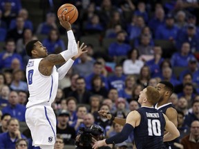 Creighton's Marcus Foster (0) shoots over Villanova's Donte DiVincenzo (10) and Villanova's Mikal Bridges, right rear, in overtime in an NCAA college basketball game against Villanova in Omaha, Neb., Saturday, Feb. 24, 2018. Foster scored 28 points in Creighton's 89-83 overtime win.